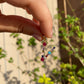 Collana lettera con pietre colorate